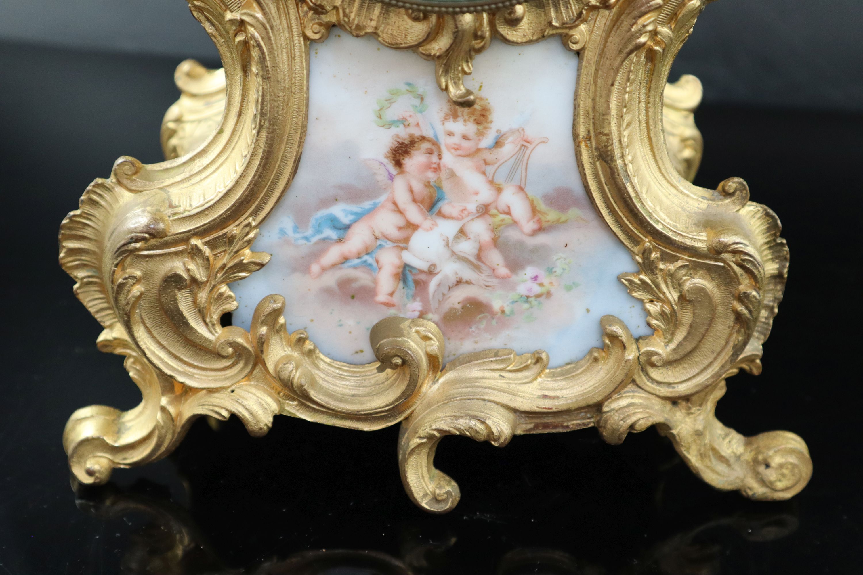 An early 20th century French gilt metal and porcelain eight day mantel clock, height 37cm